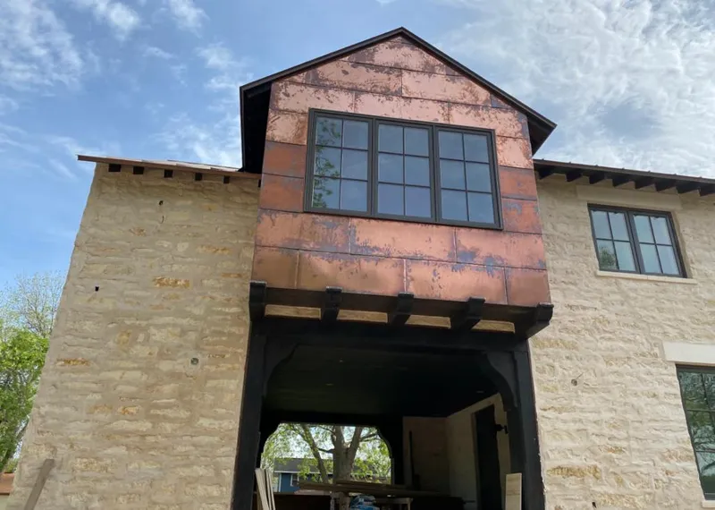 Copper metal panel facade on a stone building for Roof Repair in Demarest